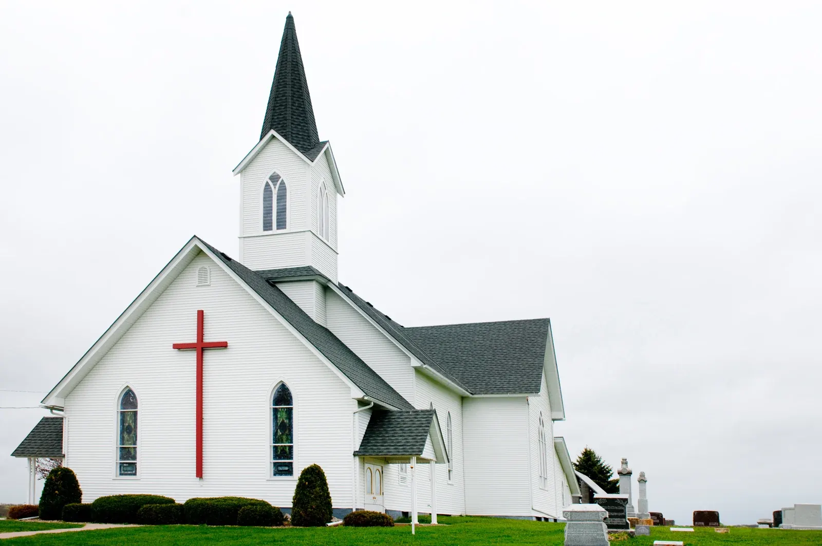 A white church surrounded by green lawn