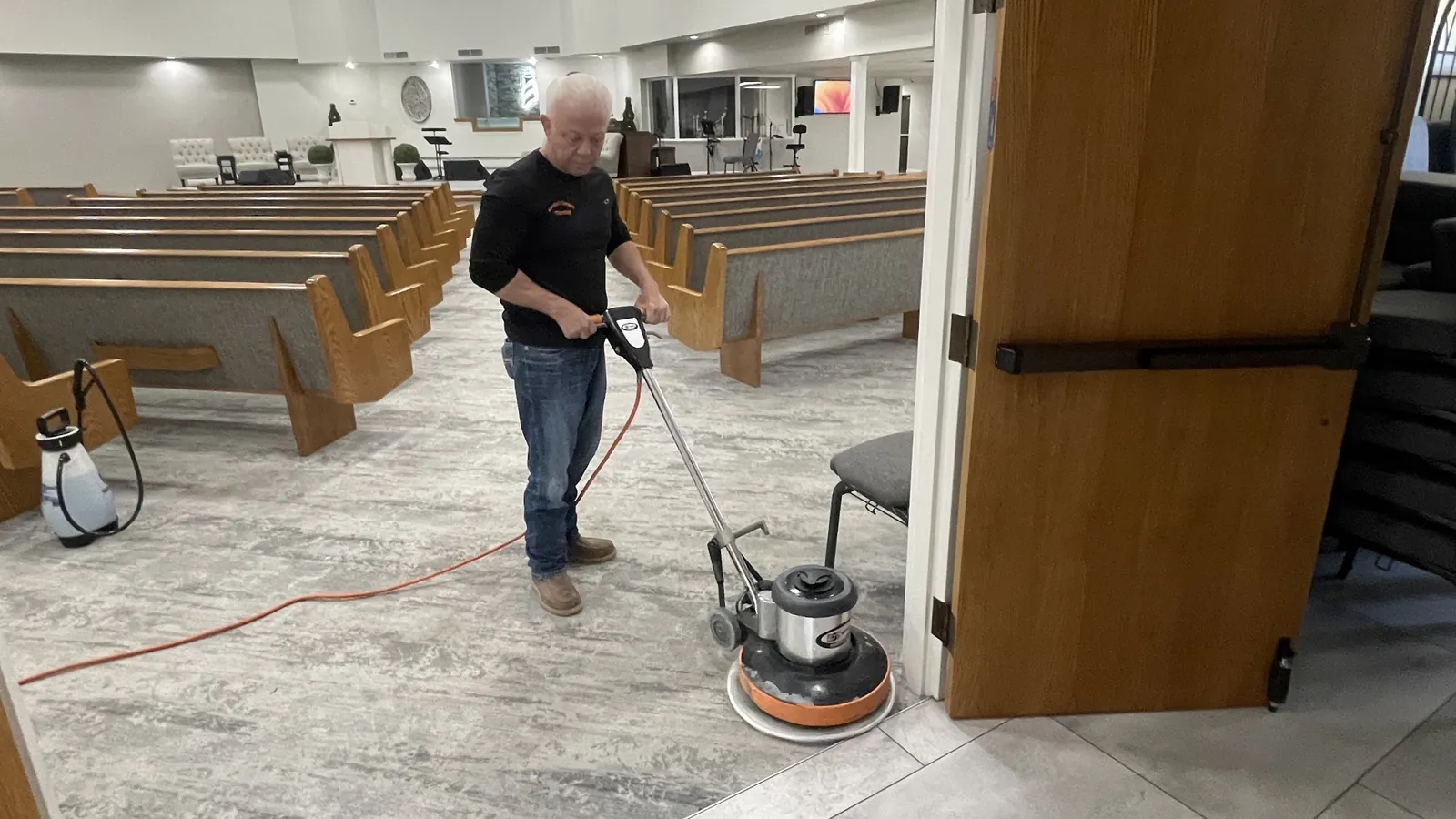 Gordon Brake cleaning the carpet near a church sanctuary entrance