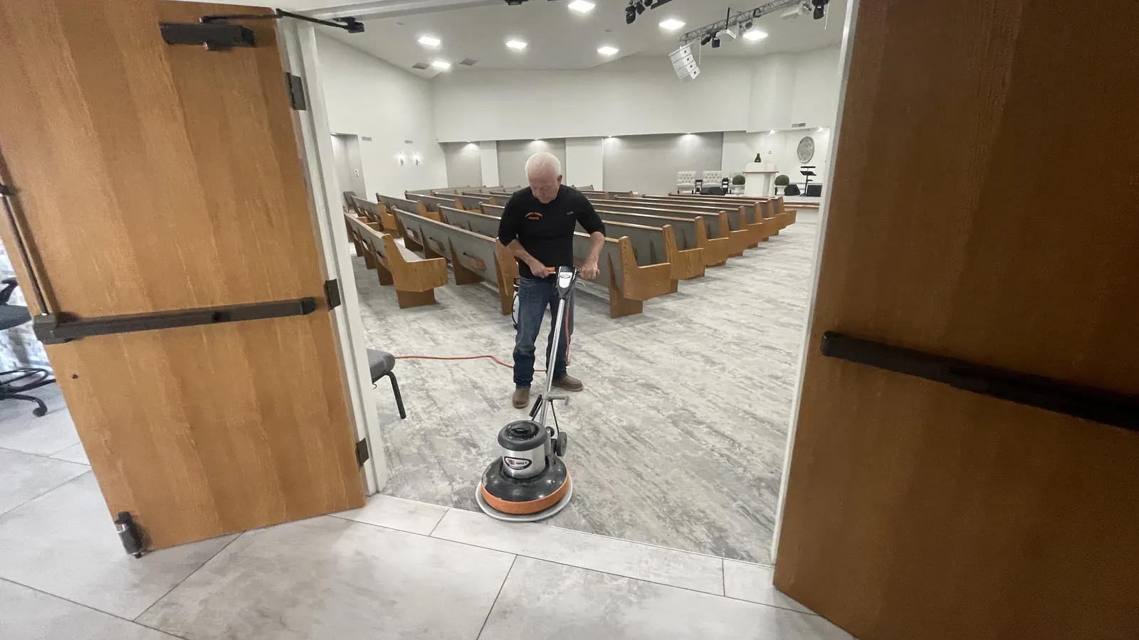Gordon Brake personally cleaning church carpet with a rotary cleaning machine
